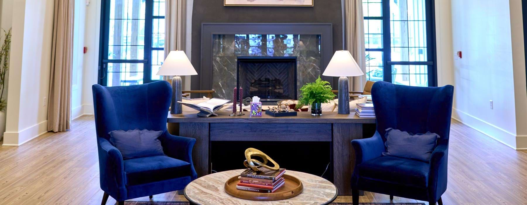 a spacious room with a fire place and chairs