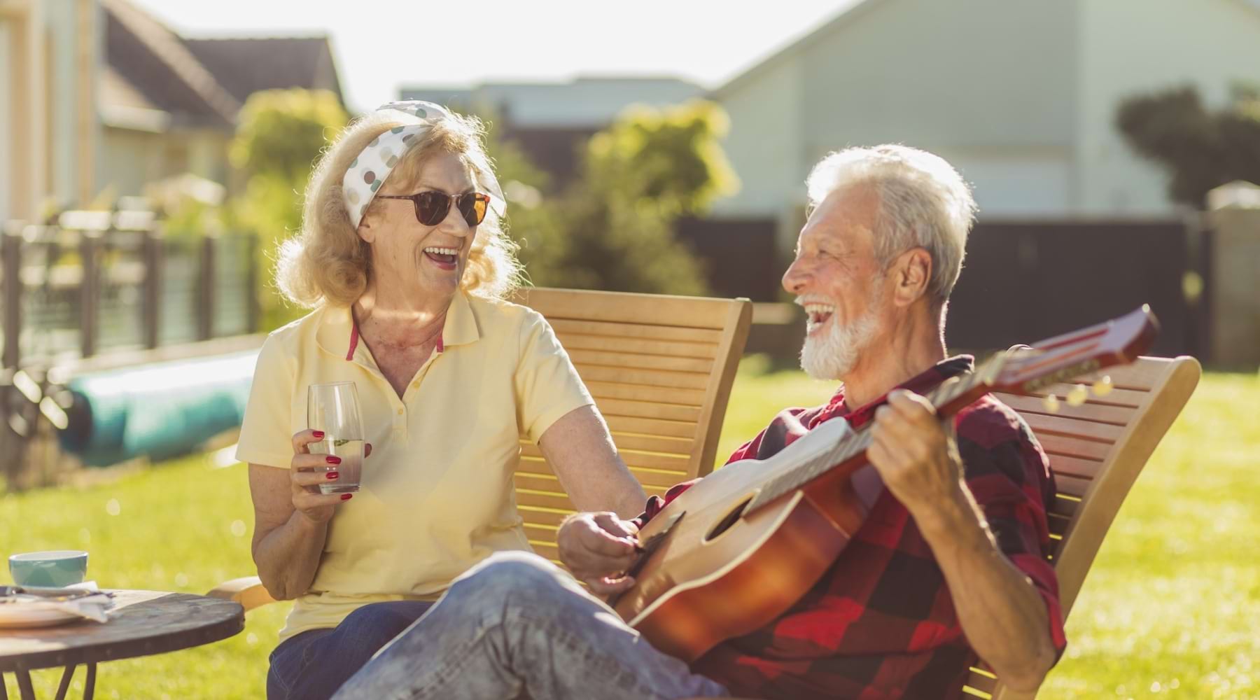 a man playing a guitar while a woman listens