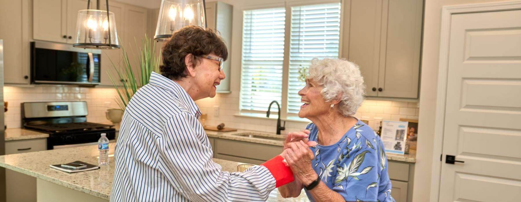 a couple of women in a kitchen